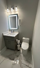 Finished powder room — marble floor, vanity, toilet